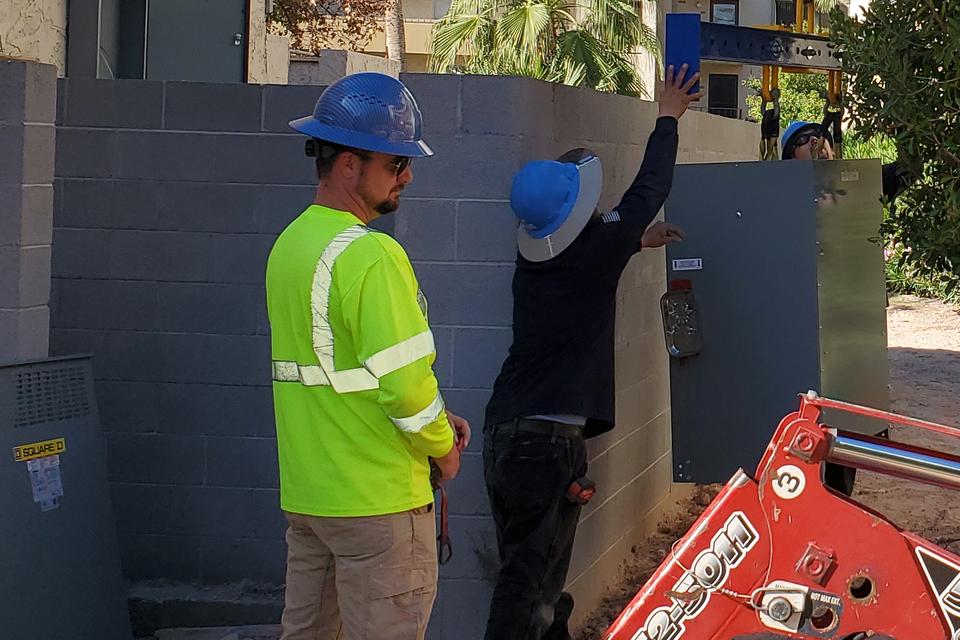 Crane setting new electrical equipment at a multifamily property in Phoenix