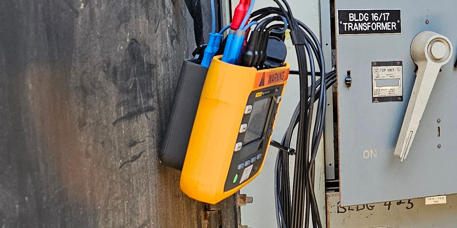 Power logger clamped onto switchboard feeders for an electrical load study